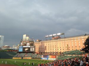 view of brick building directly behind camden yards with scoreboard