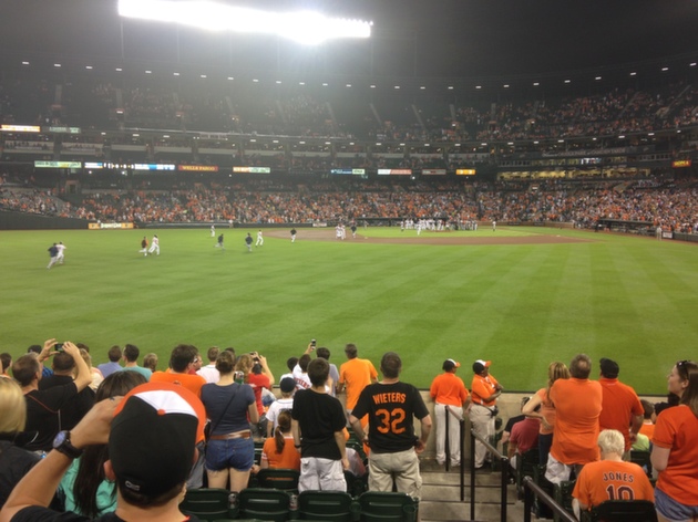 orioles players running back infield during night game
