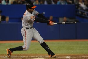 orioles player schoop up to bat after hitting baseball