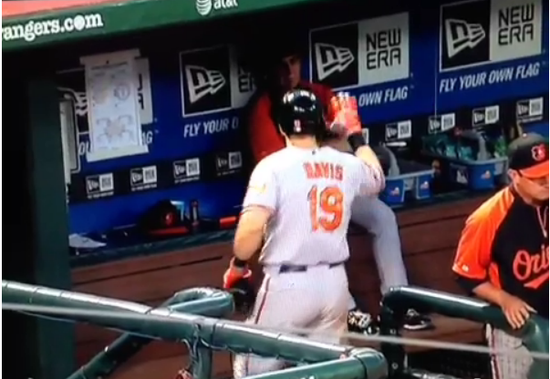 davis in orioles dugout about to high five someone