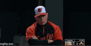 orioles manager with arms crossed scowling