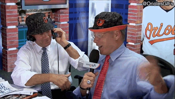 two men sitting together one with microphone the other wearing a headset