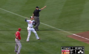 referee pointing with orioles player about to throw ball