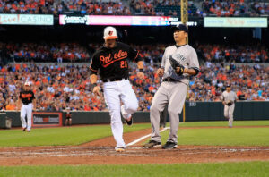 orioles player at home base with yankees pitcher next to him