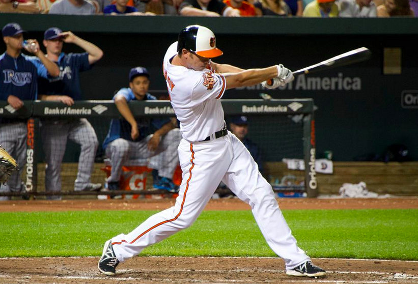 orioles player jj hardy with bat extended out in front of him after hitting ball