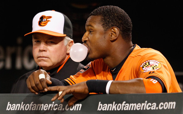 orioles player blowing bubble from gum standing next to team manager