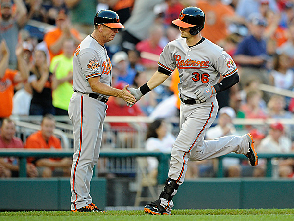 orioles player smacking base coach's hand while running by