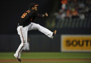 orioles player with arm out and one leg up in air