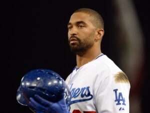 dodgers baseball player holding helmet in hand