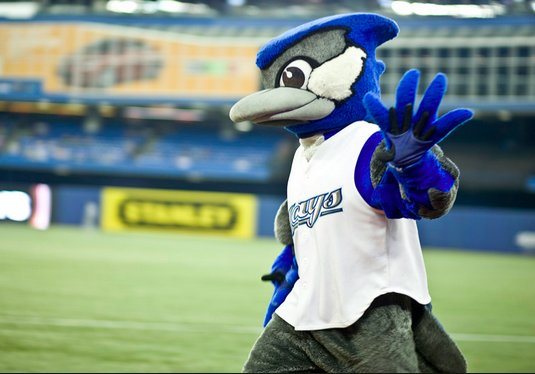 blue jays mascot walking on baseball field waving