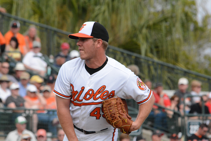 pitcher for orioles watching after having thrown pitch