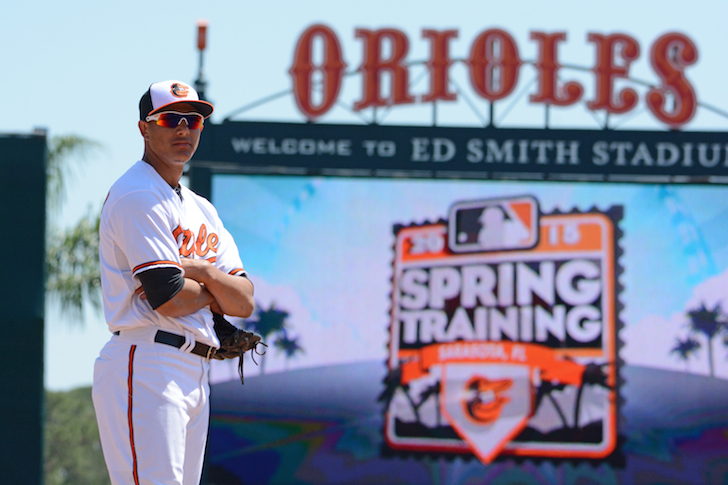 Manny Machado in front of sign at spring training 2015.