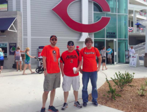 group of three men in front of baseball team store