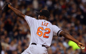 ball player with arms stretched about to throw baseball