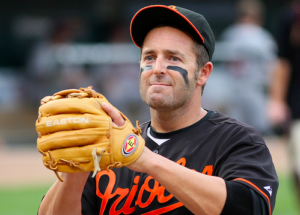 baseball player with both arms up ball in glove