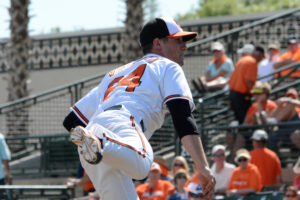 maryland orioles player body hunched over after throwing pitch