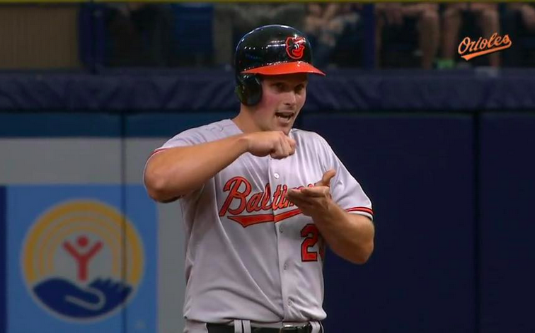 Travis Snider mimicks eating after a hit for the Orioles.