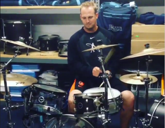 caleb joseph playing drums in a room