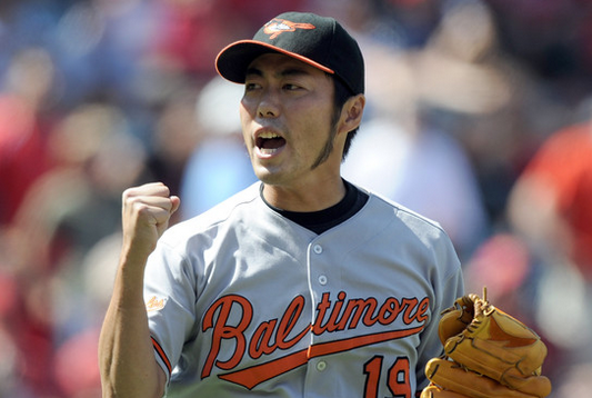 koji uehara with fist in air holding glove and excited look