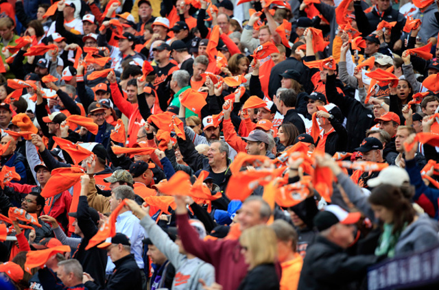 crowd of baltimore orioles fans in seats waving towels