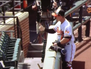 baseball player giving thumbs up to stands