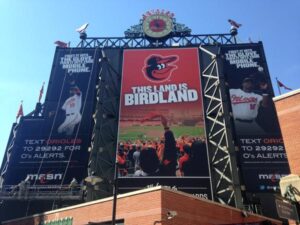 orioles billboard and clock outside of stadium