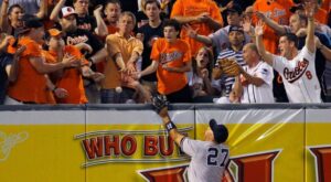 orioles fans about to catch yankees ball in stands