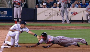 orioles player sliding into base getting tagged out