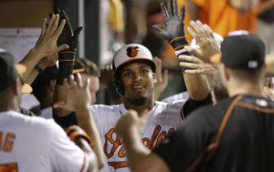 orioles player jimmy paredes high fiving through a crowd