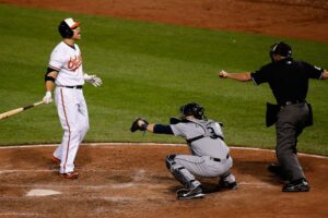 orioles player yelling at home plate to referee and catcher