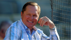 up close photo of man smiling with net behind him