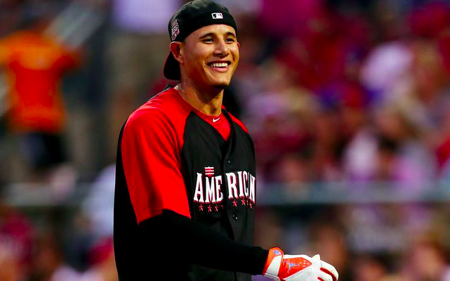 manny machado smiling with hat backwards and blurred crowd behind him