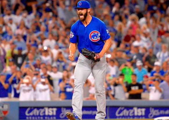 cubs jake arrieta with clenched fists and fans in background celebrating no-hitter