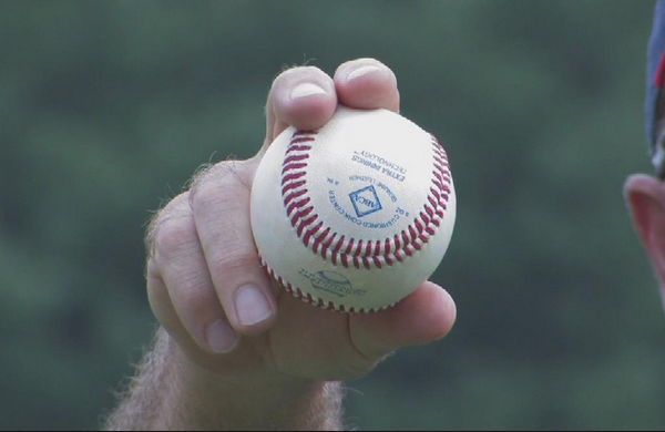 A pitcher shows how to grip a cutter.