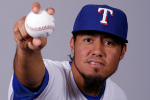 Yovani Gallardo holds a baseball.