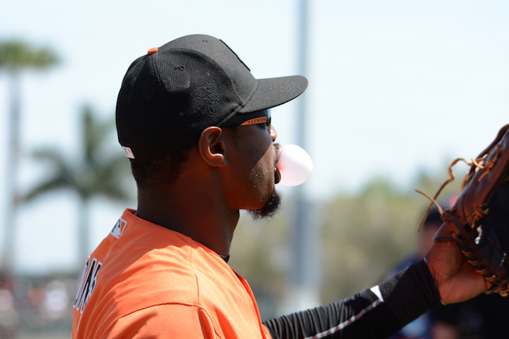 Adam Jones catches and blows a bubble.