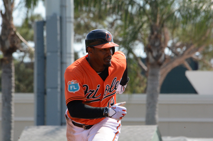 Adam jones takes off running from second base to third.