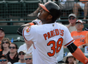 Jimmy Paredes finishes his swing as fans look on.