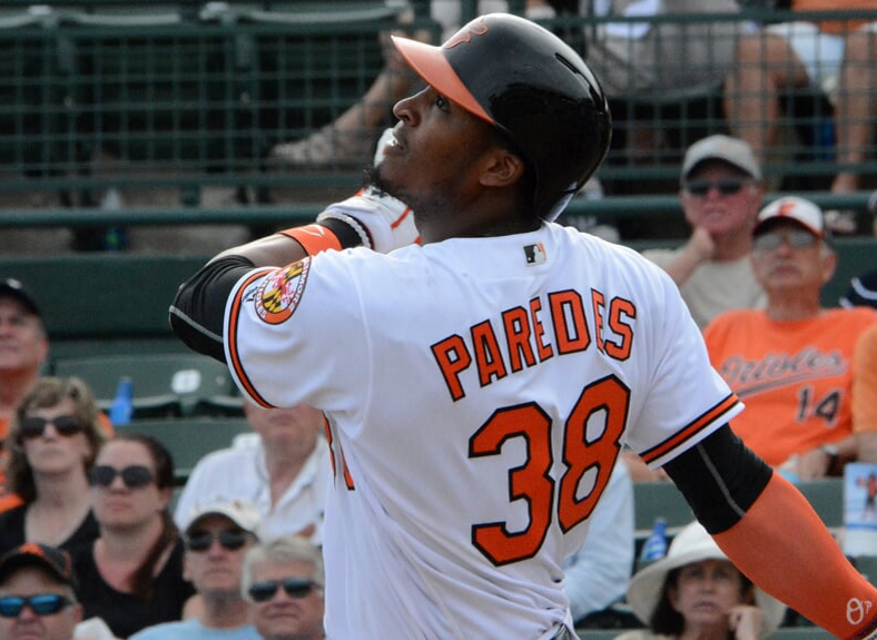 Jimmy Paredes finishes his swing as fans look on.