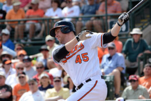 Mark Trumbo swings in a spring training game.