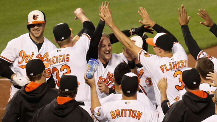 The Orioles celebrate at home plate after a walk-off passed ball against the Toronto Blue Jays.