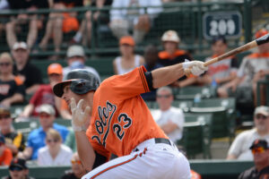 Joey Rickard swings in Spring Training.