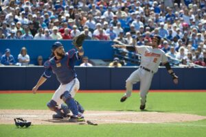 Orioles SS JJ Hardy slides into home plate against the Toronto Blue Jays