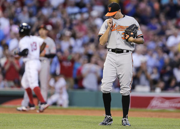 Orioles P Kevin Gausman rubs his eyes after giving up a 3-run home run to Hanley Ramirez and the Boston Red Sox.