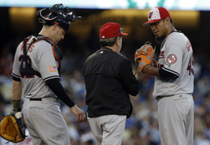 Orioles catcher, pitching coach, and pitcher talk on the mound.