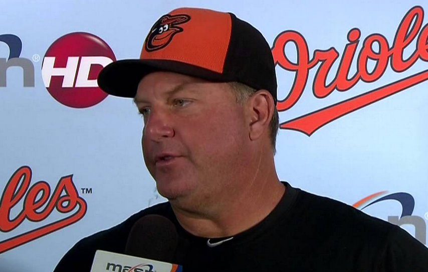 Orioles hitting coach with a microphone in front of his face.