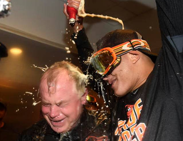 Buck Showalter and Manny Machado celebrate in the Orioles clubhouse.