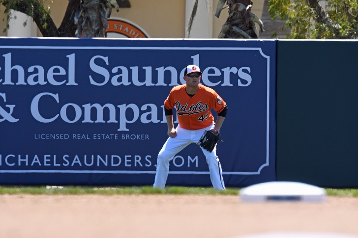 Mark Trumbo of the Orioles in ready position in the outfield.