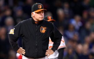 Buck Showalter stands with his hands on his hips.