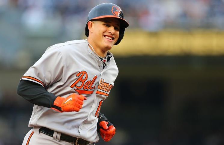 Baltimore Oriole Manny Machado laughs as he rounds the bases.